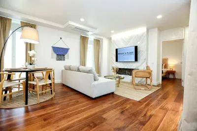 a living room with a white couch and a table at Green Algarve Gem Spacious 2 BDR By Misha's Place in Faro