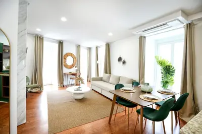 a living room with a table and a couch at GREEN BLISS IN FARO, Central One-Bed Oasis in Faro