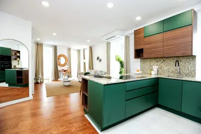 a kitchen with green cabinets and a living room at GREEN BLISS IN FARO, Central One-Bed Oasis in Faro