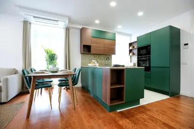 a kitchen with green cabinets and a table and chairs at GREEN BLISS IN FARO, Central One-Bed Oasis in Faro