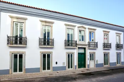 a white building with green doors and windows at GREEN BLISS IN FARO, Central One-Bed Oasis in Faro