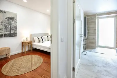 a living room with a bed and a glass door at GREEN BLISS IN FARO, Central One-Bed Oasis in Faro