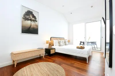 a bedroom with a bed and a couch and a table at GREEN FARO, MODERN DUPLEX with A BLISS TERRACE in Faro