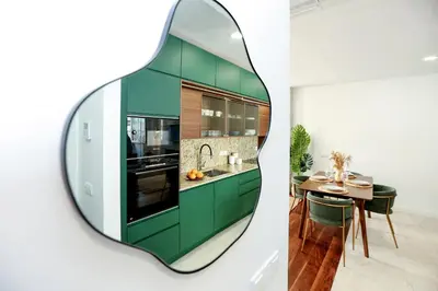 a kitchen with green cabinets and a mirror at GREEN FARO, MODERN DUPLEX with A BLISS TERRACE in Faro