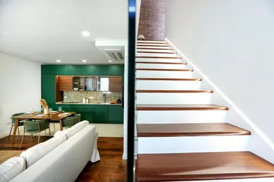 a staircase leading up to a living room and a dining room at GREEN FARO, MODERN DUPLEX with A BLISS TERRACE in Faro