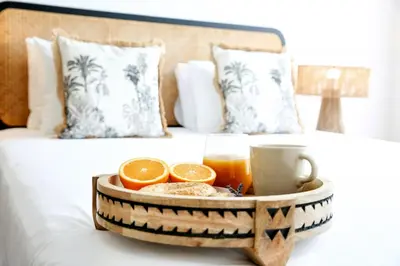 a tray of breakfast food on a bed at GREEN FARO, MODERN DUPLEX with A BLISS TERRACE in Faro