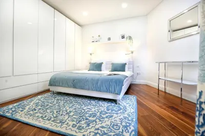 a bedroom with a bed and a flat screen tv at Green & Gorgeous - 3 bedroom Getaway in the Heart in Faro