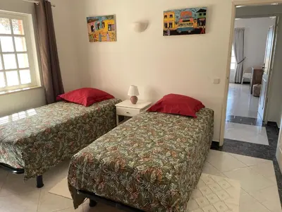 two beds in a room with two red pillows at Cabana do Monte in Santa Bárbara de Nexe