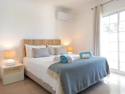 a bedroom with a large bed with towels on it at Vila Lana - Heated pool - Sea view - Two independent floors in Faro