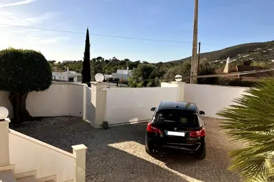 a car parked in a driveway next to a white fence at Vila Lana - Heated pool - Sea view - Two independent floors in Faro