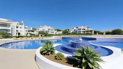 a swimming pool with a fountain in a resort at Green Valley 03- CleverDetails, Monte Verde, lux, distant sea view, 3 bedroom, 4 saltwater pools in Vilamoura