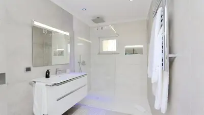 a white bathroom with a sink and a shower at Green Valley 03- CleverDetails, Monte Verde, lux, distant sea view, 3 bedroom, 4 saltwater pools in Vilamoura