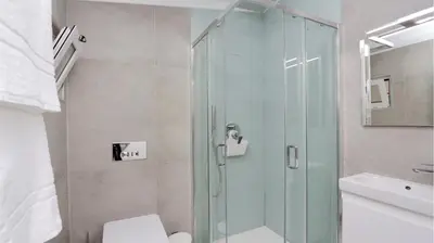 a bathroom with a shower with a toilet and a sink at Green Valley 03- CleverDetails, Monte Verde, lux, distant sea view, 3 bedroom, 4 saltwater pools in Vilamoura