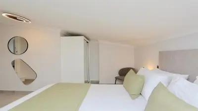 a white bedroom with a large bed and a mirror at Green Valley 03- CleverDetails, Monte Verde, lux, distant sea view, 3 bedroom, 4 saltwater pools in Vilamoura