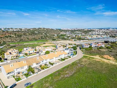 an aerial view of a city with houses and a road at Marina Vista Retreat in Albufeira