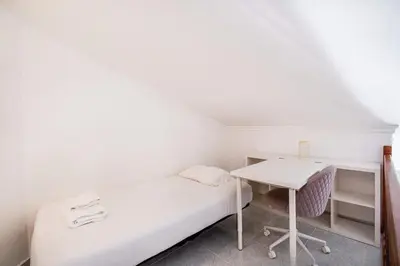 a small room with a bed and a desk at Marina Vista Retreat in Albufeira