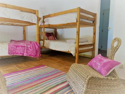 a living room with two bunk beds and a chair at Fashion Villa in Vilamoura with Private Pool in Quarteira