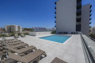 a swimming pool on the roof of a building at Terraços de Quarteira II Frolic by Real Properties in Cavacos