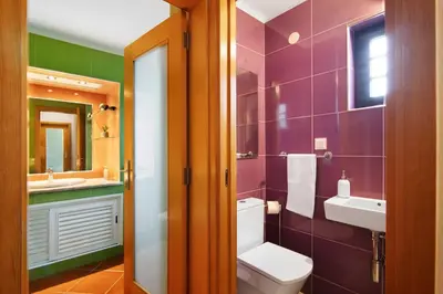 a bathroom with a toilet and a sink at Ema Clube em Albufeira in Albufeira