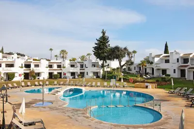a large swimming pool in front of some white apartments at Ema Clube em Albufeira in Albufeira