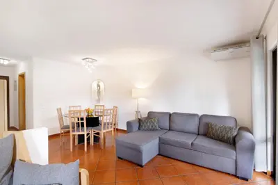 a living room with a couch and a table at Ema Clube em Albufeira in Albufeira