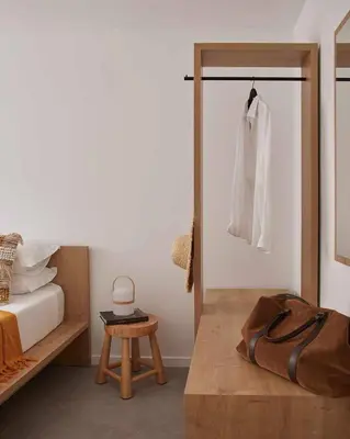 a bedroom with a bed and a white shirt hanging on a door at Casa Pateo in Albufeira