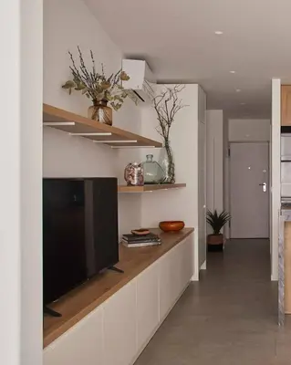 a living room with a flat screen tv on a wall at Casa Pateo in Albufeira