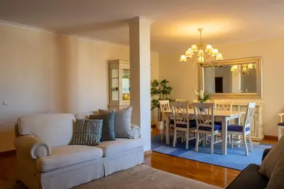 a living room with a couch and a dining room at Miradouro da Penha in Faro