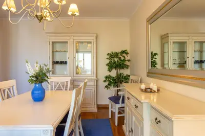 a dining room with a table and a mirror at Miradouro da Penha in Faro