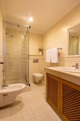a bathroom with a sink and a toilet and a shower at Miradouro da Penha in Faro