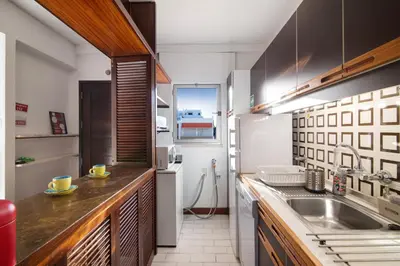 a kitchen with a sink and a refrigerator at Good Wave House in Vilamoura