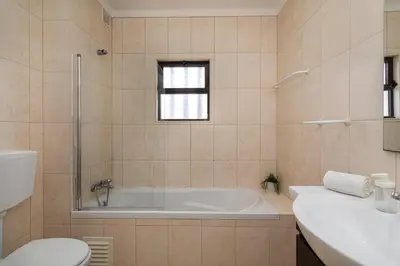 a bathroom with a tub and a toilet and a sink at TAC - Sea Apartments 2D in Albufeira