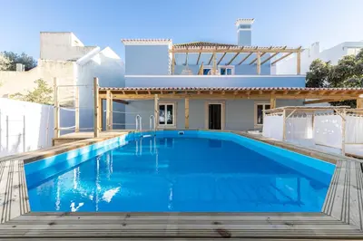 a swimming pool in front of a villa at Amália Boutique Suites & Studios - by @ rita´s place in Faro