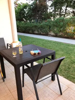 a black table and chairs with a bottle and drinks on it at Casa Rachael in Albufeira
