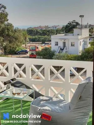 a chair and a glass table on a balcony at HIMALAYA ROOFTOP Sea VIEW in Albufeira