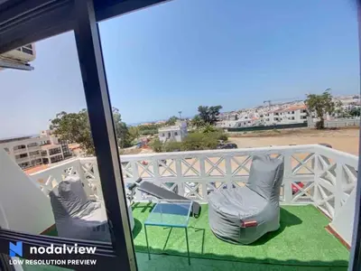 a balcony with two chairs and a view of the beach at HIMALAYA ROOFTOP Sea VIEW in Albufeira
