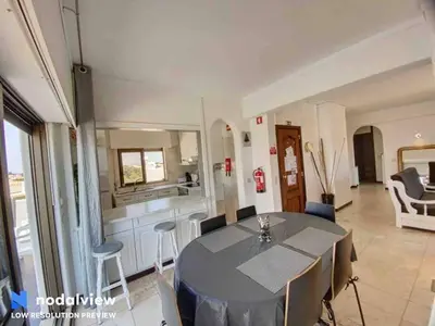 a dining room with a table and a kitchen at HIMALAYA ROOFTOP Sea VIEW in Albufeira