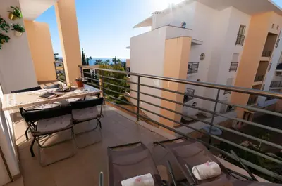 a balcony of a building with chairs and a table at Encosta da Orada by OCvillas in Albufeira