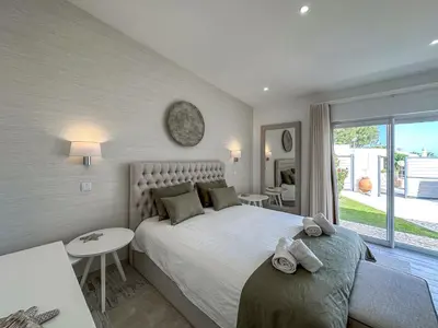 a bedroom with a large bed with towels on it at Luxury Villa Heated Pool, walk to São Rafael Beach, Albufeira in Albufeira