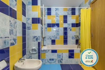 a bathroom with a toilet and a sink and a tub at Marina de Albufeira Villa 8 in Albufeira