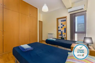 a small room with two beds and a cabinet at Marina de Albufeira Villa 8 in Albufeira