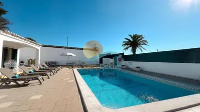 a swimming pool with chaise lounge chairs next to a building at Villa Bea by Sunny Deluxe in Albufeira