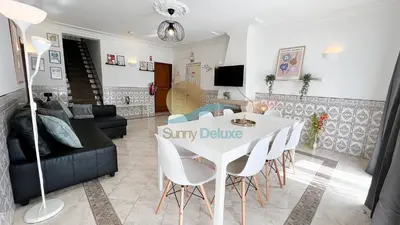 a living room with a white table and chairs at Villa Bea by Sunny Deluxe in Albufeira