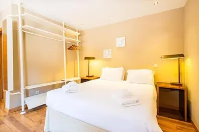 a bedroom with a white bed with towels on it at Villa Palm Retreat - Beautiful idyllic views in Boliqueime