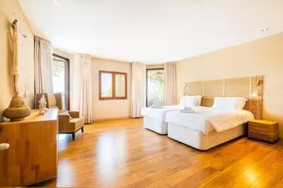 a large bedroom with a large bed and a couch at Villa Palm Retreat - Beautiful idyllic views in Boliqueime