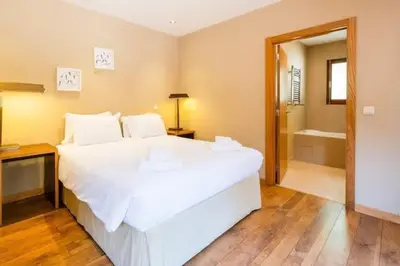 a bedroom with a large white bed and a bath tub at Villa Palm Retreat - Beautiful idyllic views in Boliqueime
