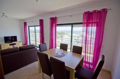 a living room with a table and a couch at Dalia in Quarteira