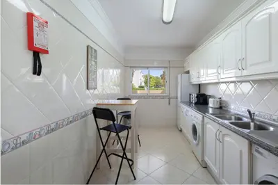 a kitchen with a sink and a dishwasher at Centralgarve - Spacious & Elegant - Vilamoura w Pool - Jacarandás in Quarteira