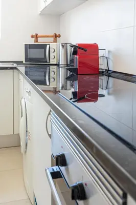 a kitchen with a counter with a red item on it at Centralgarve - Cosy&Central 1bdrm in Vilamoura - Pateos da Marina in Vilamoura