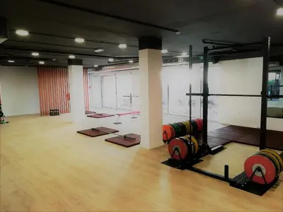 a gym with dumbbells in a large room at Falésia Cliff Apartment by The Portuguese Butler in Albufeira